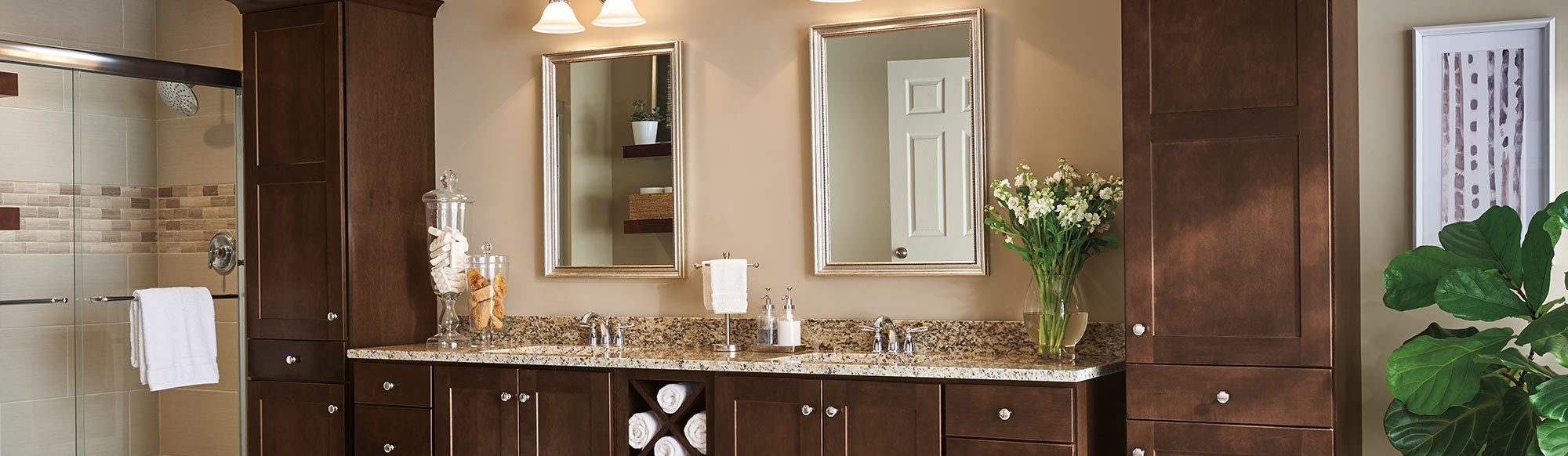 bathroom with marble countertops and wooden cabinetry