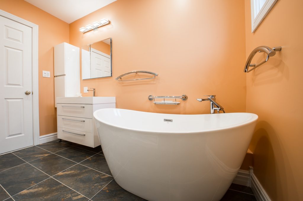 bathroom with orange walls and white amenities
