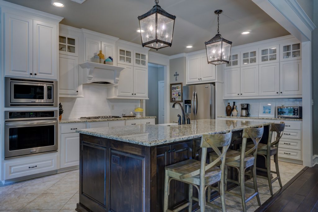 kitchen with center island , white cabinets, and stainless steel appliances