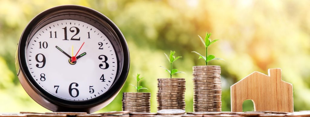 clock with stacks of coins growing larger
