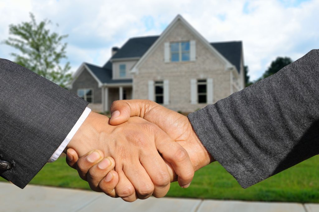 real estate investor shaking hands on deal