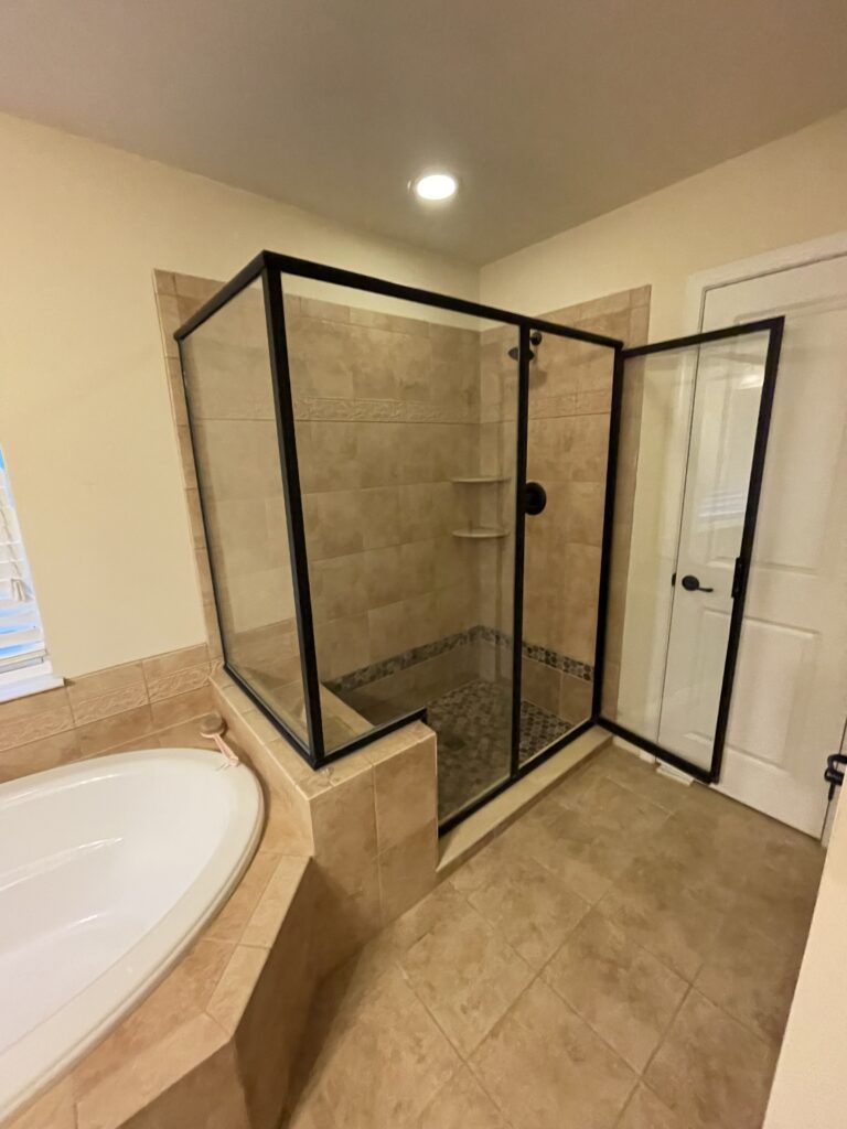 Modern bathroom with a glass shower enclosure. North Hills Bathroom Renovations.