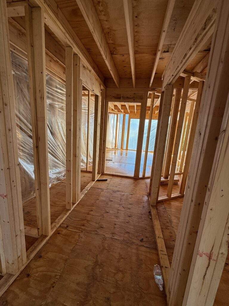 New home construction framing: wood studs and plywood subfloor.