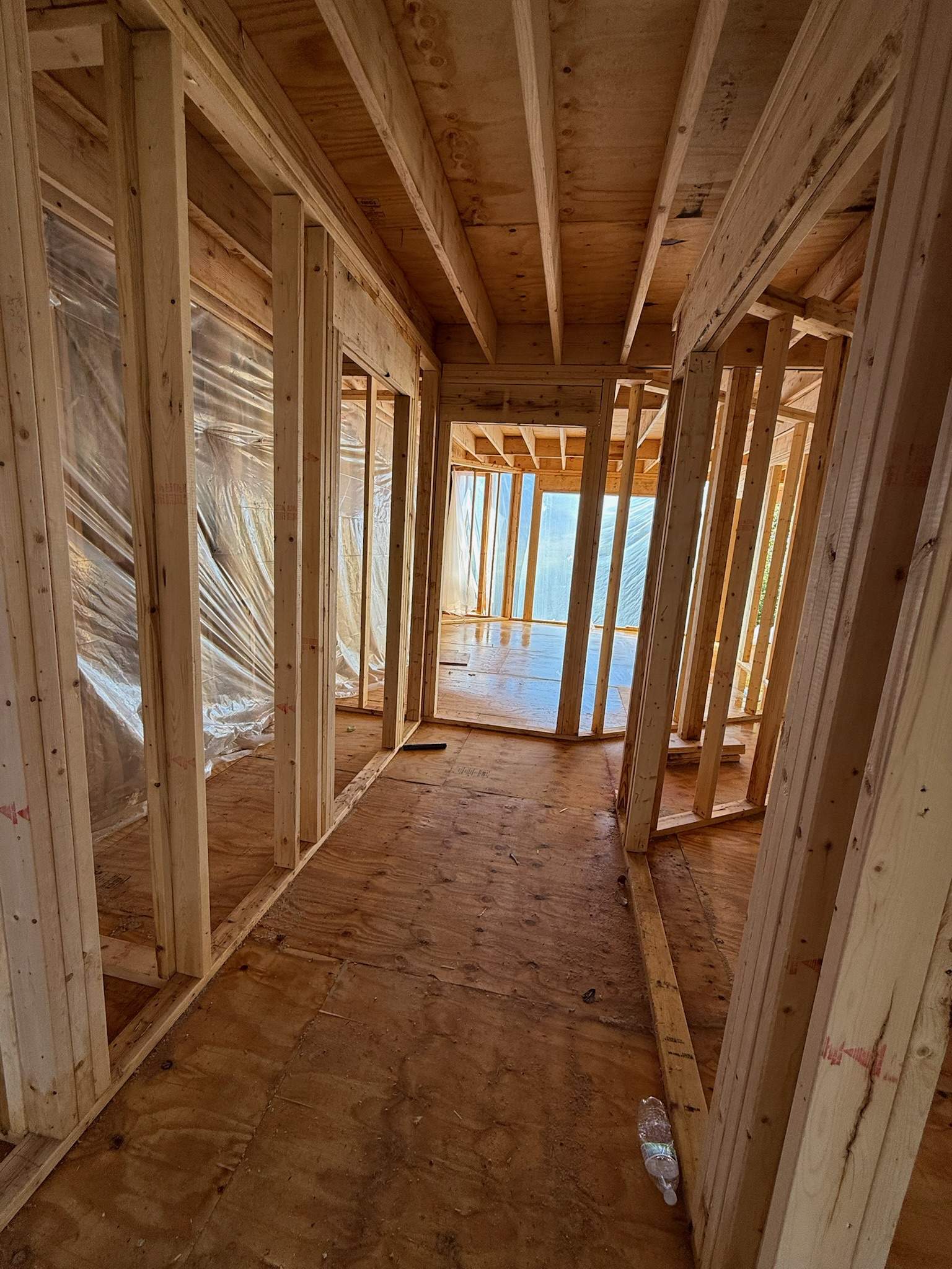 New home construction framing: wood studs and plywood subfloor.
