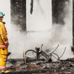 Firefighter surveys damage from fire damage mitigation and restoration in Pittsburgh.