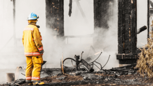 Firefighter surveys damage from fire damage mitigation and restoration in Pittsburgh.