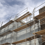 Scaffolding on a building under construction, with stone facade.