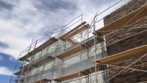 Scaffolding on a building under construction, with stone facade.