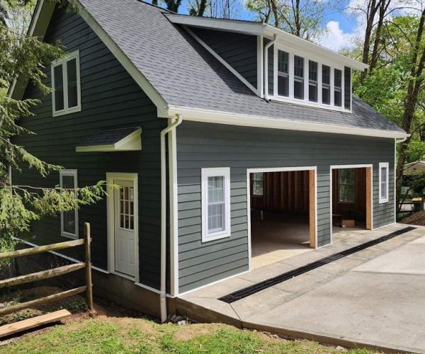 New garage in Pittsburgh with gray siding, white trim, and dormer windows.