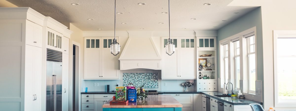 white walled kitchen with  island and table with chairs white walled kitchen with island and table with chairs